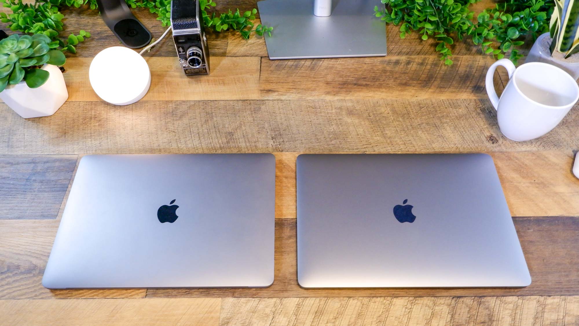 MacBook Pro 13-inch (M1, 2021) sitting on a desk next to a MacBook Pro 13-inch (M2, 2022)