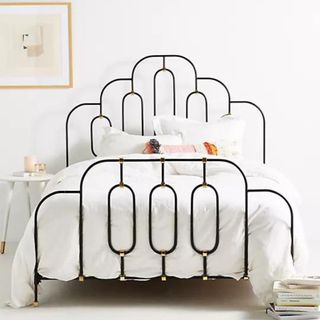 Deco Bed Frame with white bedding against a white wall.