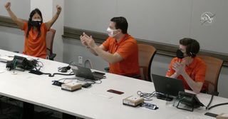 NASA Mars Helicopter Ingenuity project manager MiMi Aung (left) celebrates with her team at the Jet Propulsion Laboratory in California after seeing images from the first successful flight on Mars by the Ingenuity helicopter on April 19, 2021