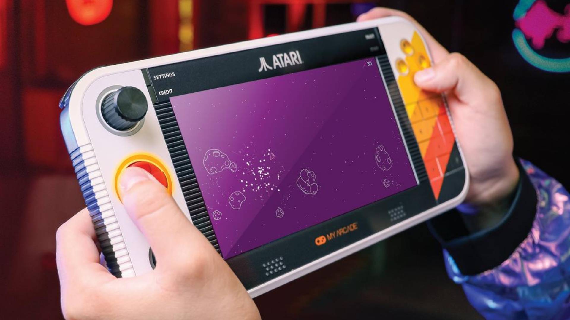 Hands holding Atari Gamestation Go with Asteroids on screen.