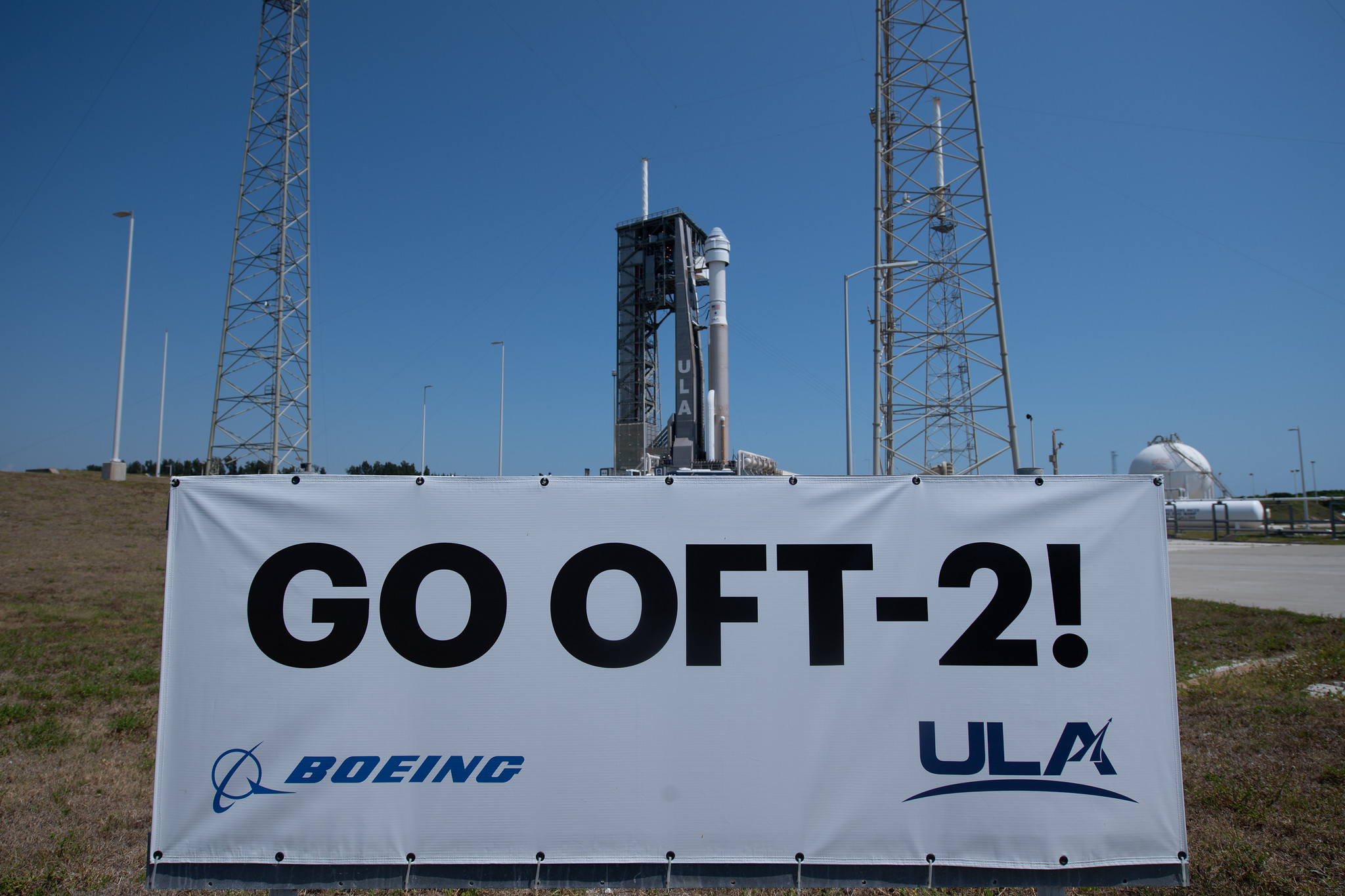 A sign supporting Boeing's Starliner OFT-2 mission at the launch pad.
