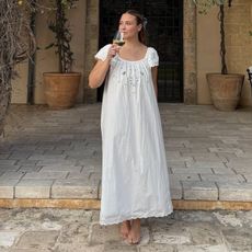 @oliviamarcus wears a white broderie anglaise dress