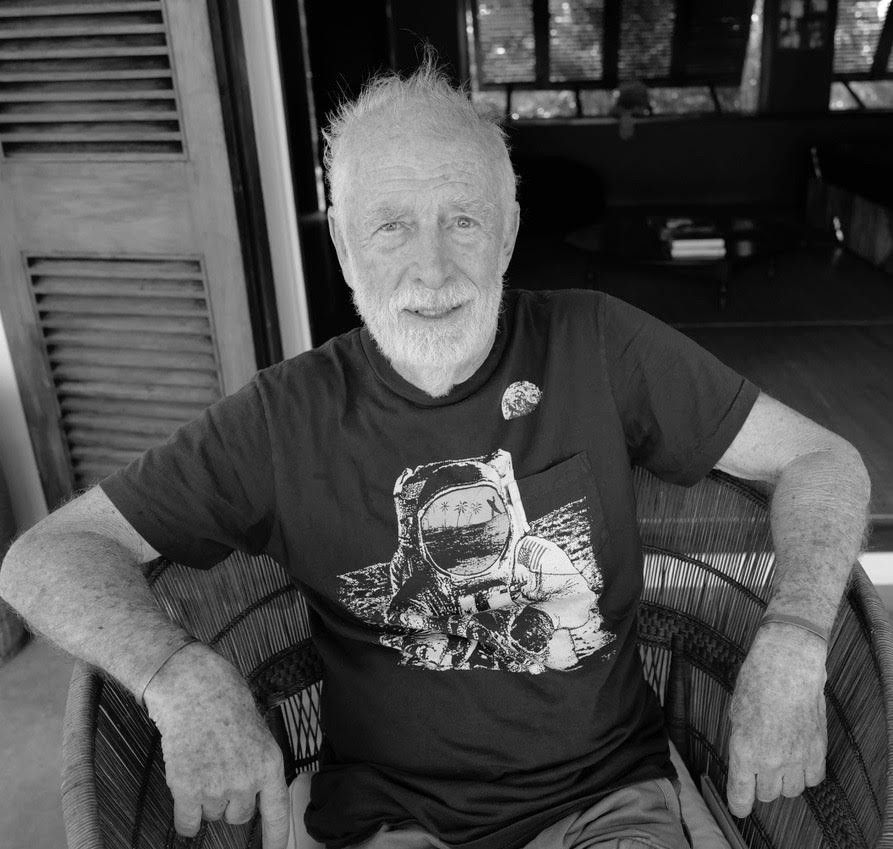 Chris Blackwell at his home, Fleming Villa, in Jamaica. Working, but not necessarily at a desk — he was on a photo shoot in this picture and taking a break. His two phones were ringing constantly, but he put them aside to pose for this picture.