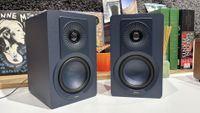 Dali Kupid speakers in blue finish on desktop