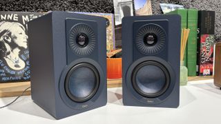 Dali Kupid speakers in blue finish on desktop