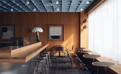 dark cherry wood paneling and modernist furniture in London space designed by Child Studio for Maido Sushi