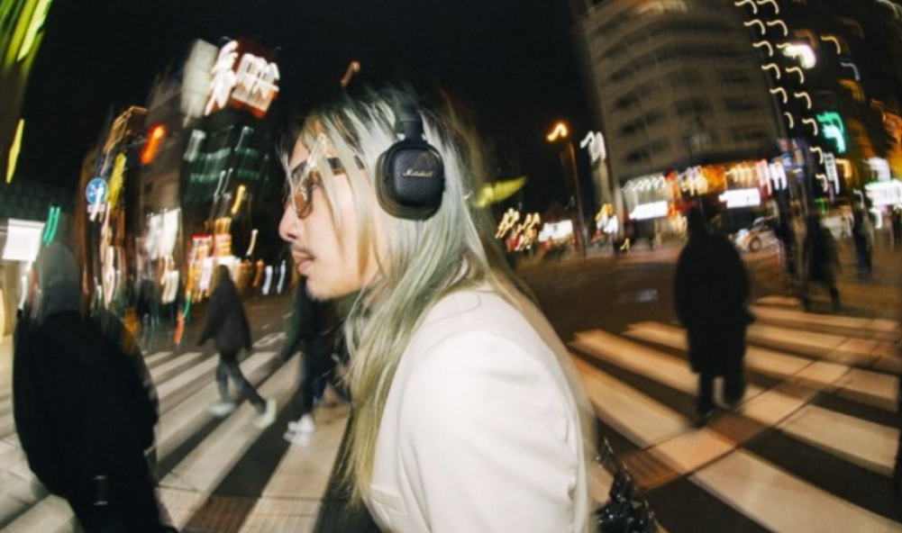 Marshall Milton ANC black wireless headphones worn by a man in a city at night 