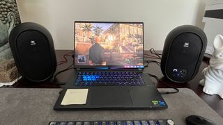 JBL 104-BT speakers on either side of a gaming laptop