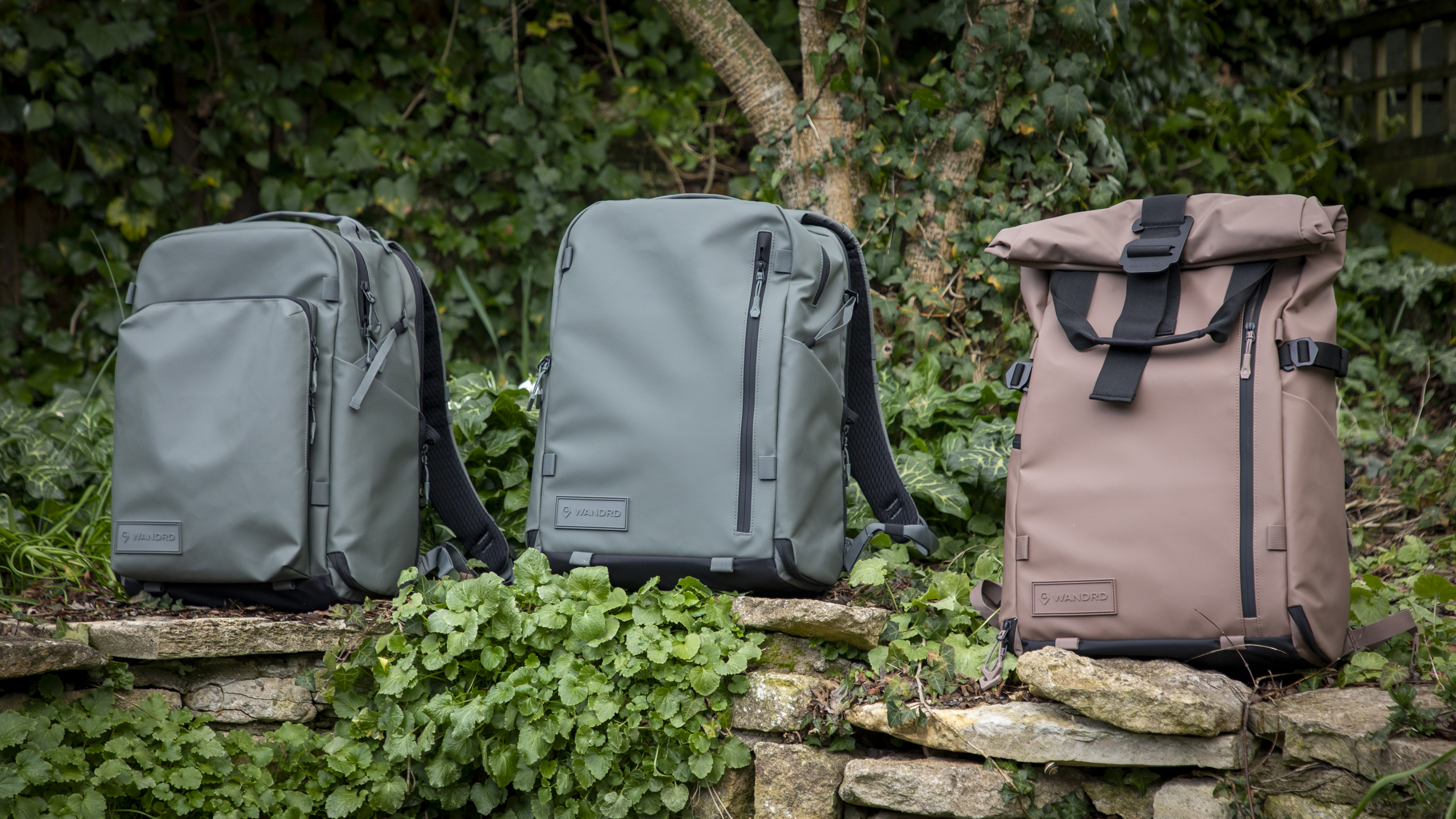 light green camera backpacks against wooden greenery background