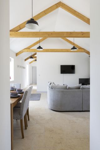 interior of a barn conversion with vaulted ceiling and exposed beams