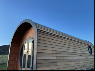 rounded wooden tiny house exeterior