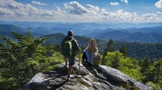 A mature couple on top of the mountain is enjoying a beautiful view. Blue Ridge Mountains, near Asheville, North Carolina.USA.