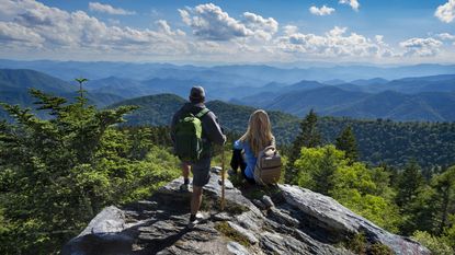 A mature couple on top of the mountain is enjoying a beautiful view. Blue Ridge Mountains, near Asheville, North Carolina.USA.