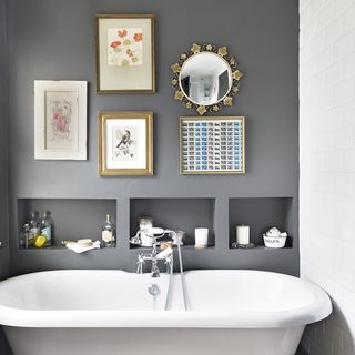 bathroom with white bathtub and photoframe on wall