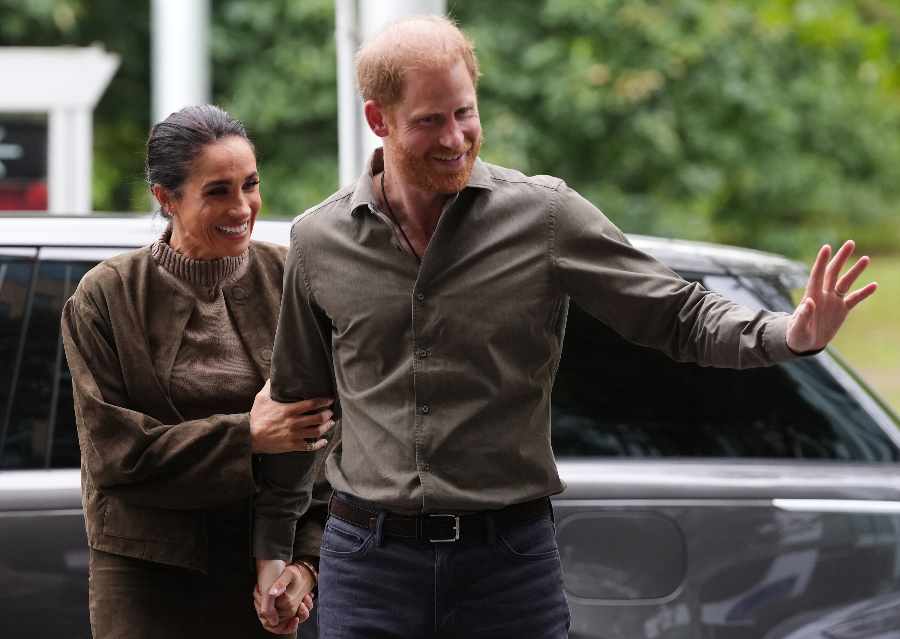 Meghan Markle holding Prince Harry's arm