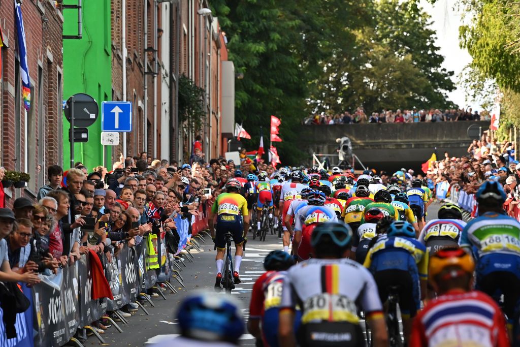 LEUVEN BELGIUM SEPTEMBER 24 A general view of the Peloton passing through Leuven City while fans cheer during the 94th UCI Road World Championships 2021 Men U23 Road Race a 1609km race from Antwerp to Leuven flanders2021 on September 24 2021 in Leuven Belgium Photo by Dirk Waem PoolGetty Images