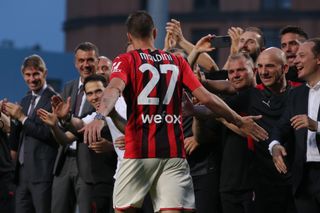 AC Milan technical director Paolo Maldini applauds as son Daniel makes his way to the winners' podium after a game against Sassuolo in May 2022.