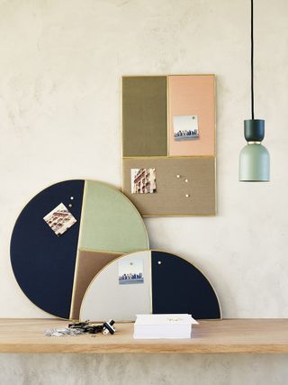 an assortment of stylish pin boards from Oliver Bonas leaning against a wall