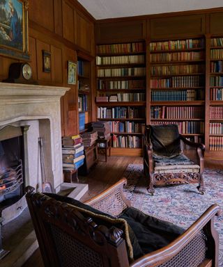 Large wood paneled library with fireplace