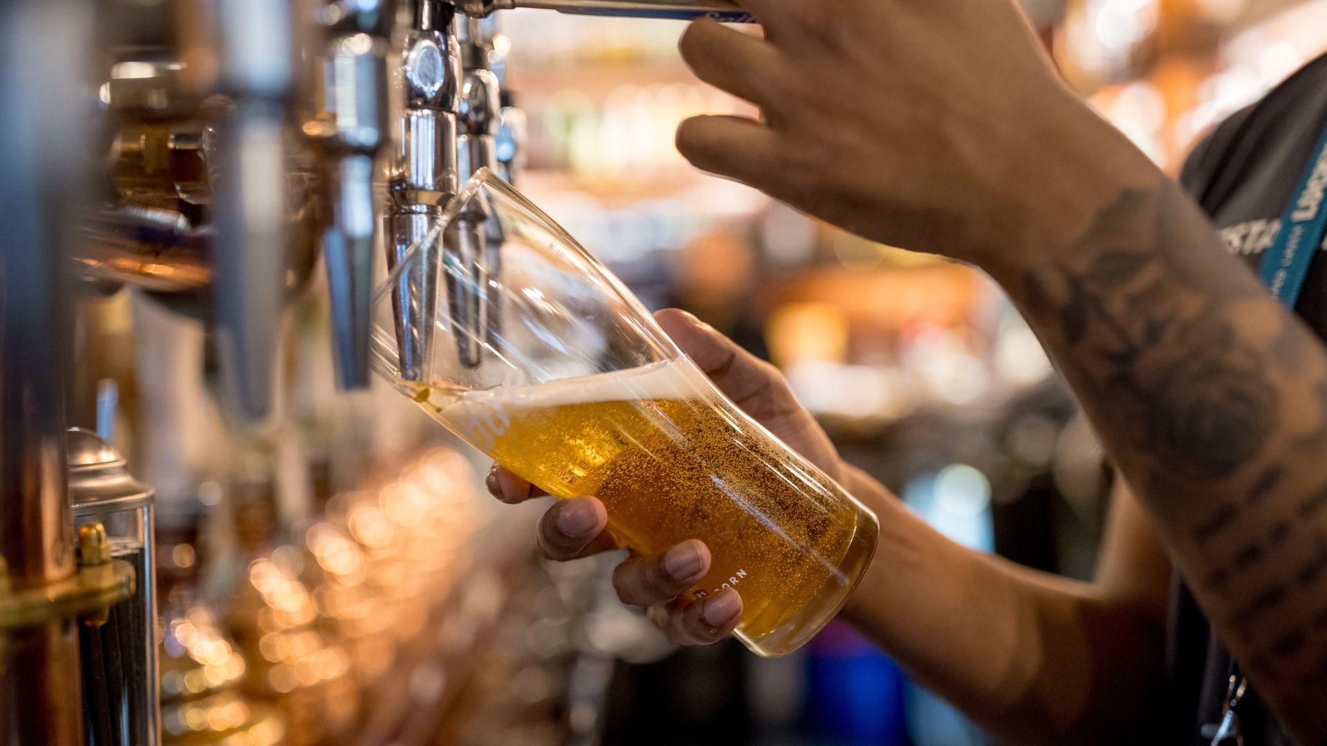 an image of a bartender pulling a pint