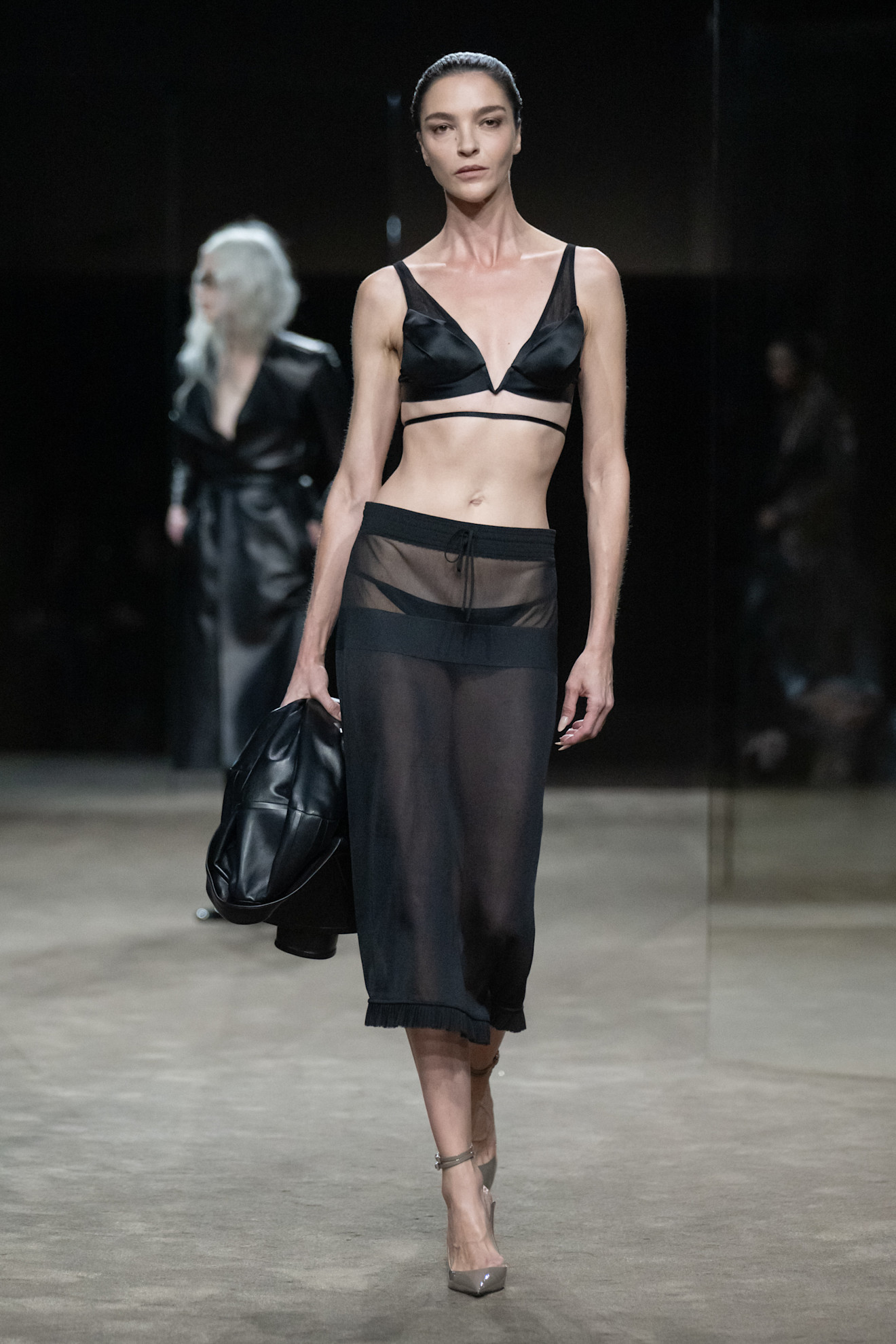 Spring/summer 2027 model wearing a bra top on the runway during fashion month.