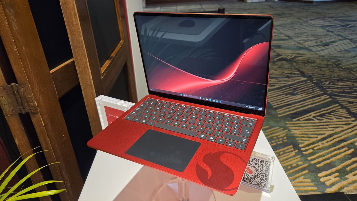 Microsoft Surface Laptop 13-inch 2nd Edition with Manchester United and Qualcomm Snapdragon branding on a red chassis, displayed with football imagery