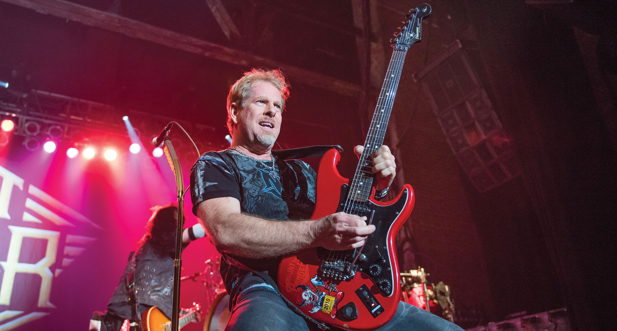 Brad Gillis takes a solo live onstage with Night Ranger. He plays his signature red Fernandes S-style with the black pickguard