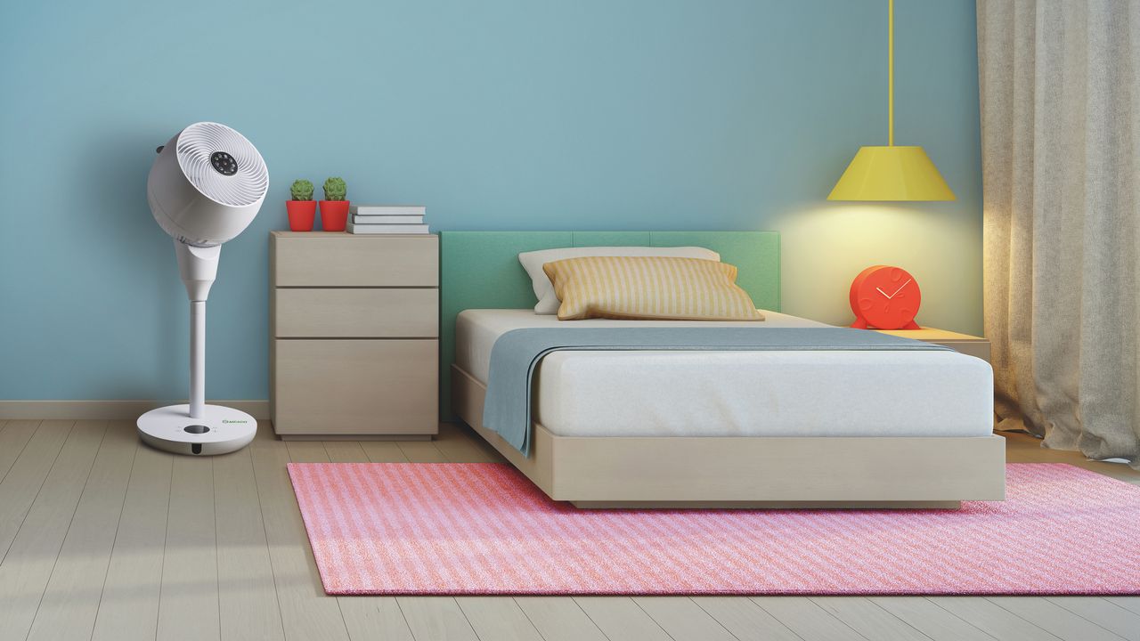 A neat and tidy bedroom environment with a floorstanding fan in one corner