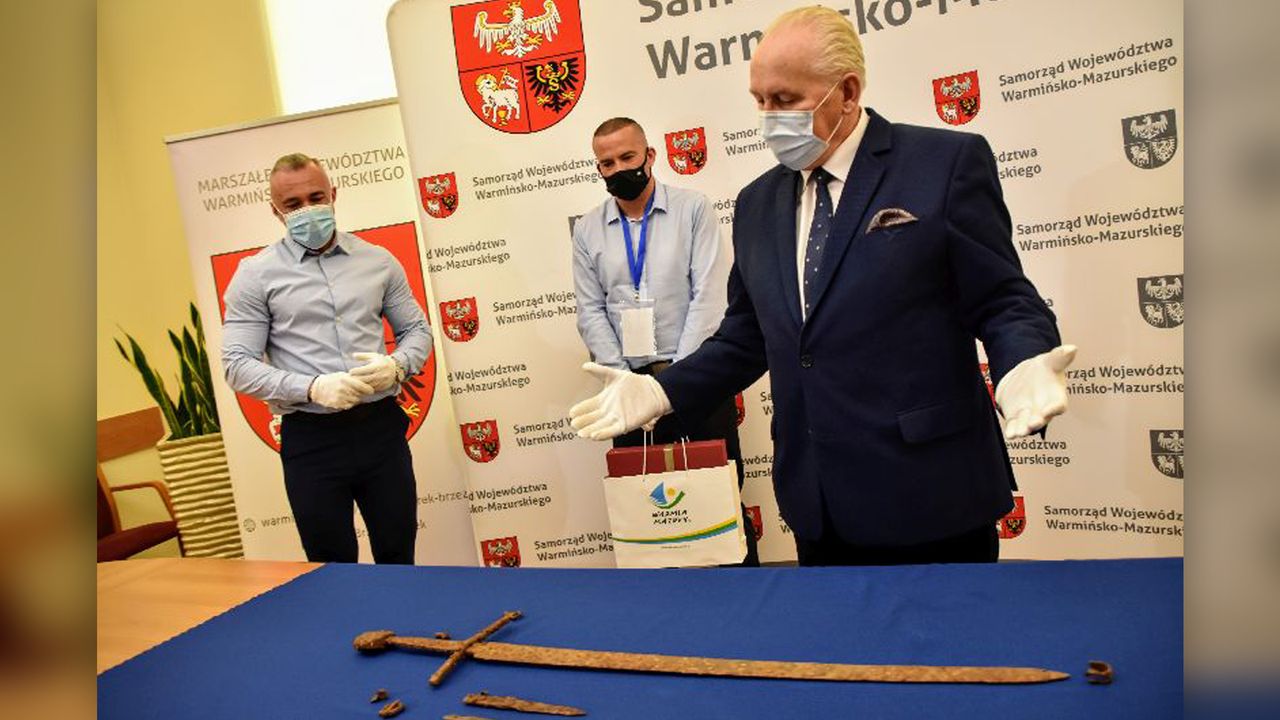 Officials presenting the sword
