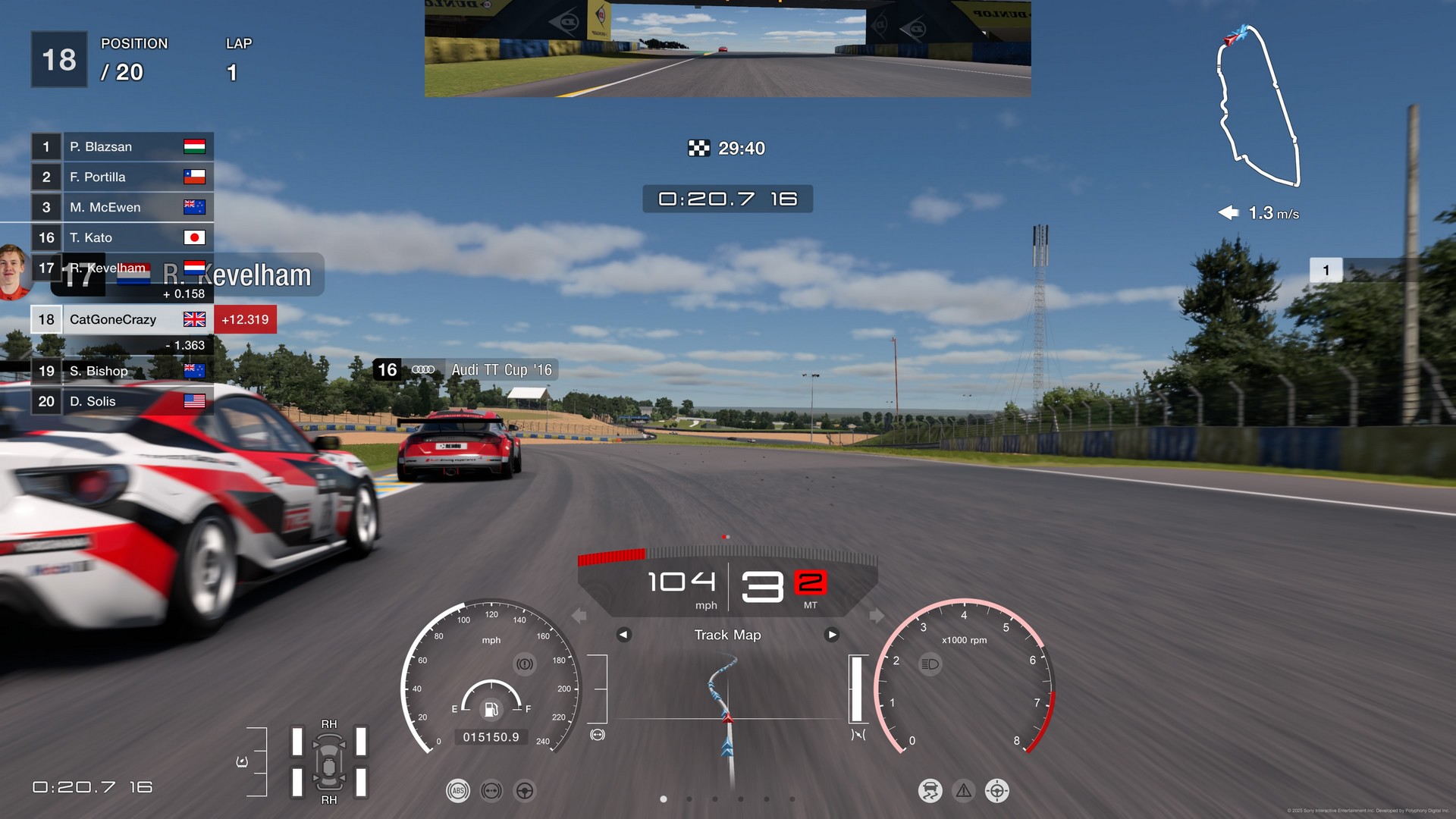 Racing in Gran Turismo 7 in first-person on a sunny day