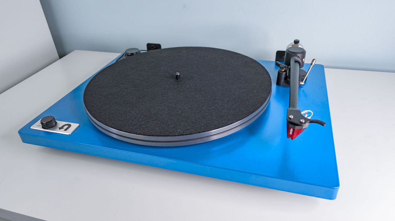 A top down view of a blue U-Turn Audio Orbit Special on a white surface
