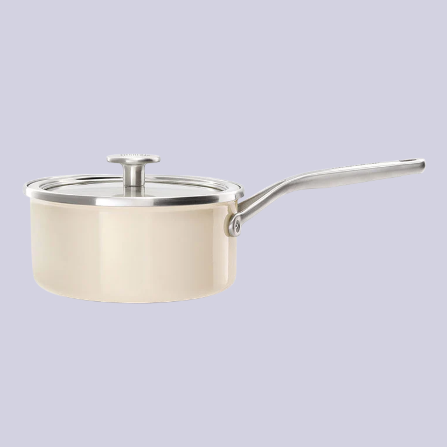 A light beige steel core enamel saucepan with a lid, against a light pastel purple background