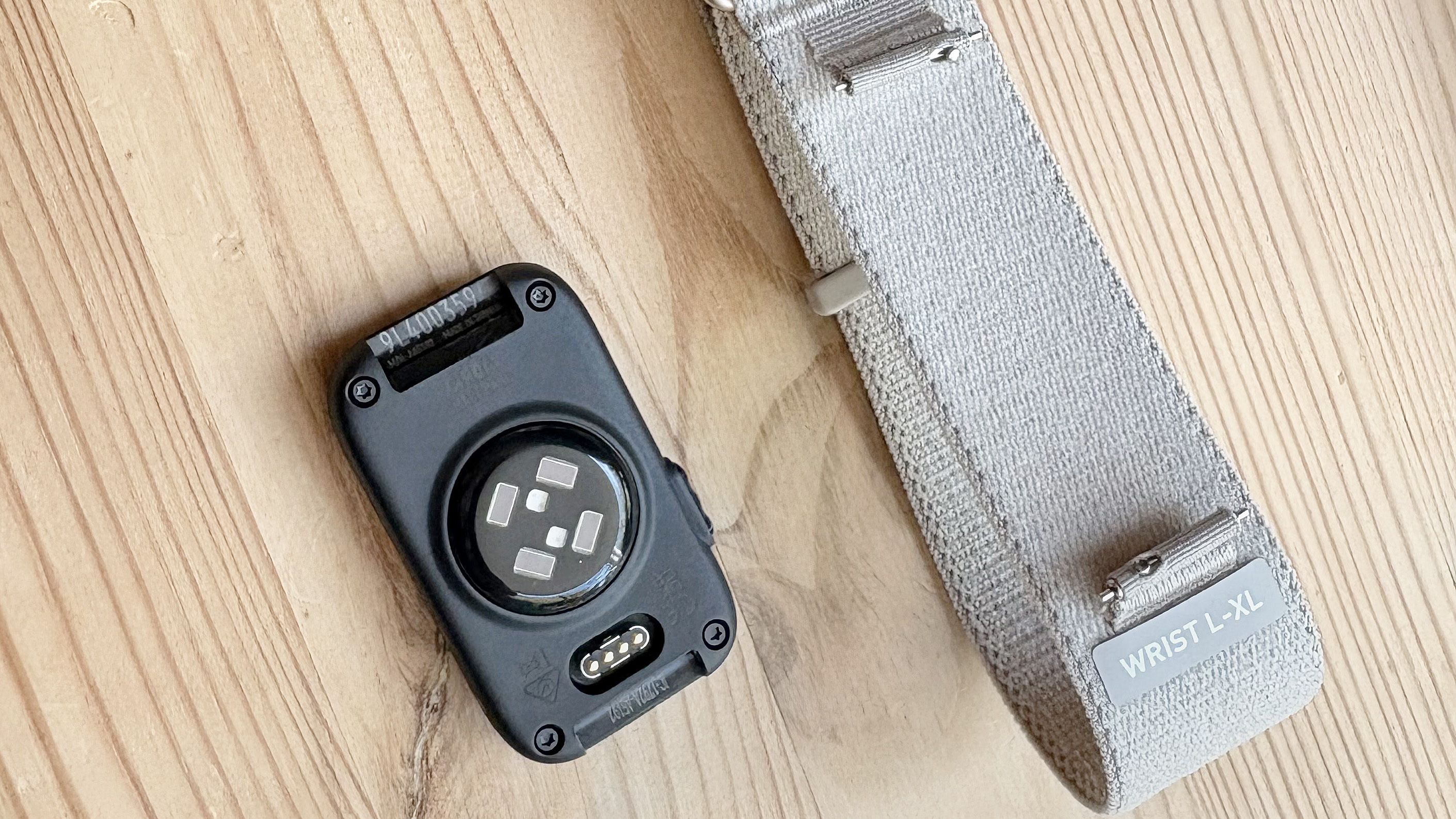Close-up of the back of the Garmin Cirqa next to its strap