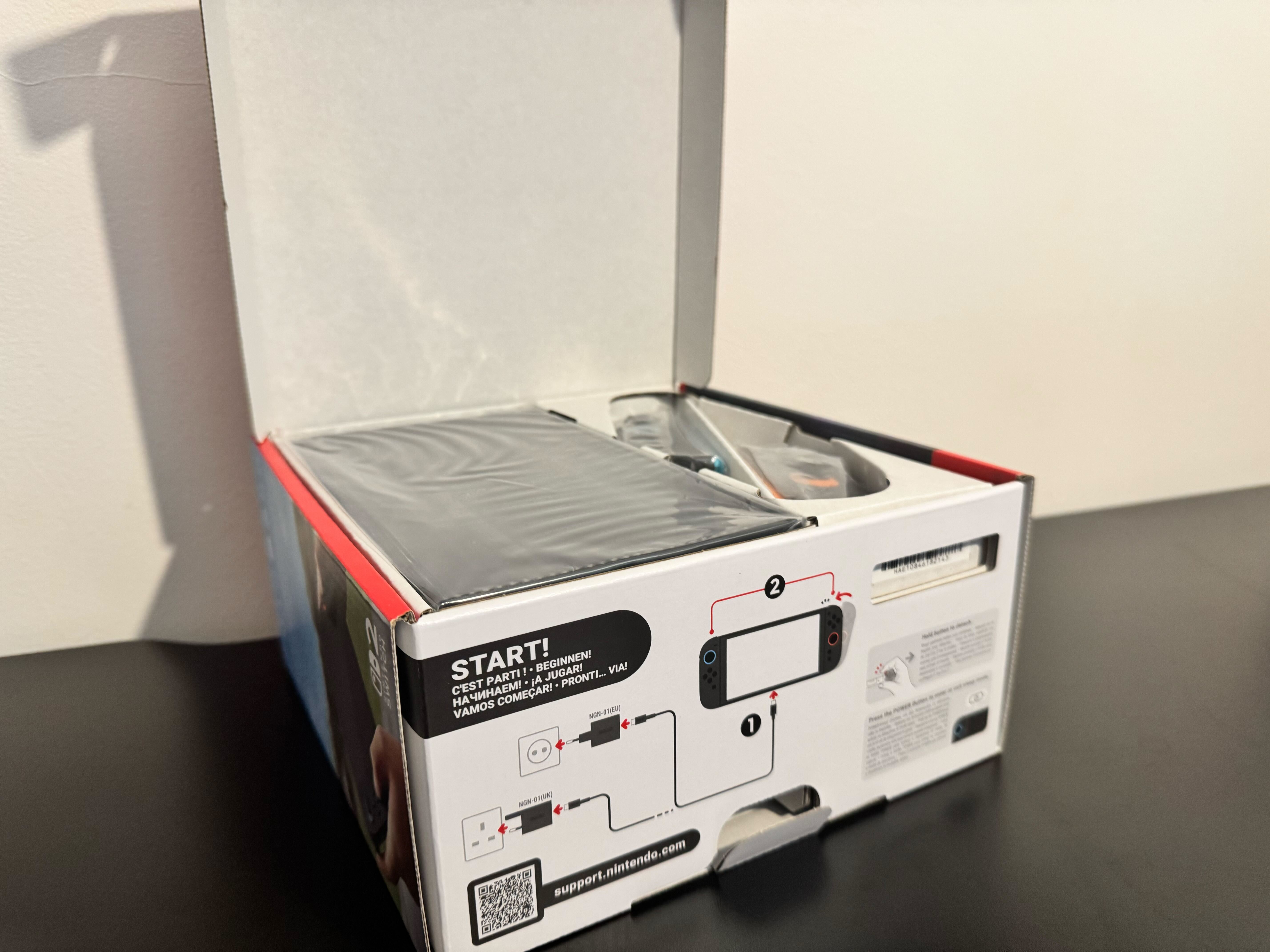An open Nintendo Switch 2 package, showing the console packed towards the outside of the box