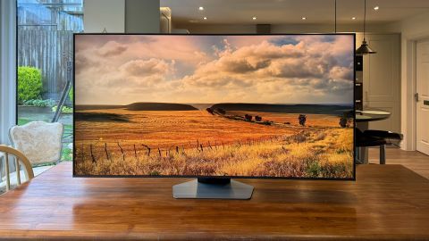 Samsung Q80D 55-inch LED TV on wooden dining table with field landscape on screen