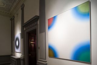 Wojciech Fangor painting's on the walls in a gallery.