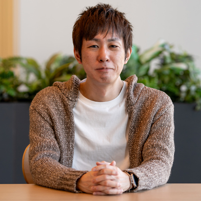 Takeo Kujiraoka sits at a table