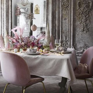 Christmas dining table with pink chairs and baubles