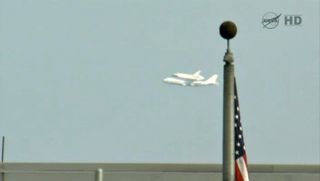 Endeavour Flies Past Flag at Johnson Space Center