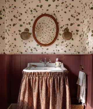 A vintage bathroom with a fabric sink skirt and panelling