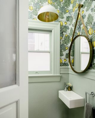 small powder room with printed wallpaper by Banner Day Interiors