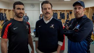 From left to right: Roy Kent, Ted Lasso and Coach Beard looking forward.