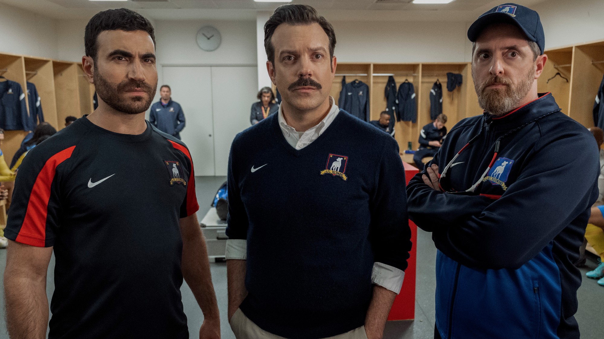 From left to right: Roy Kent, Ted Lasso and Coach Beard looking forward. 