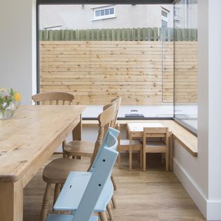 dinning area with wooden flooring white walls and dinning table with chairs