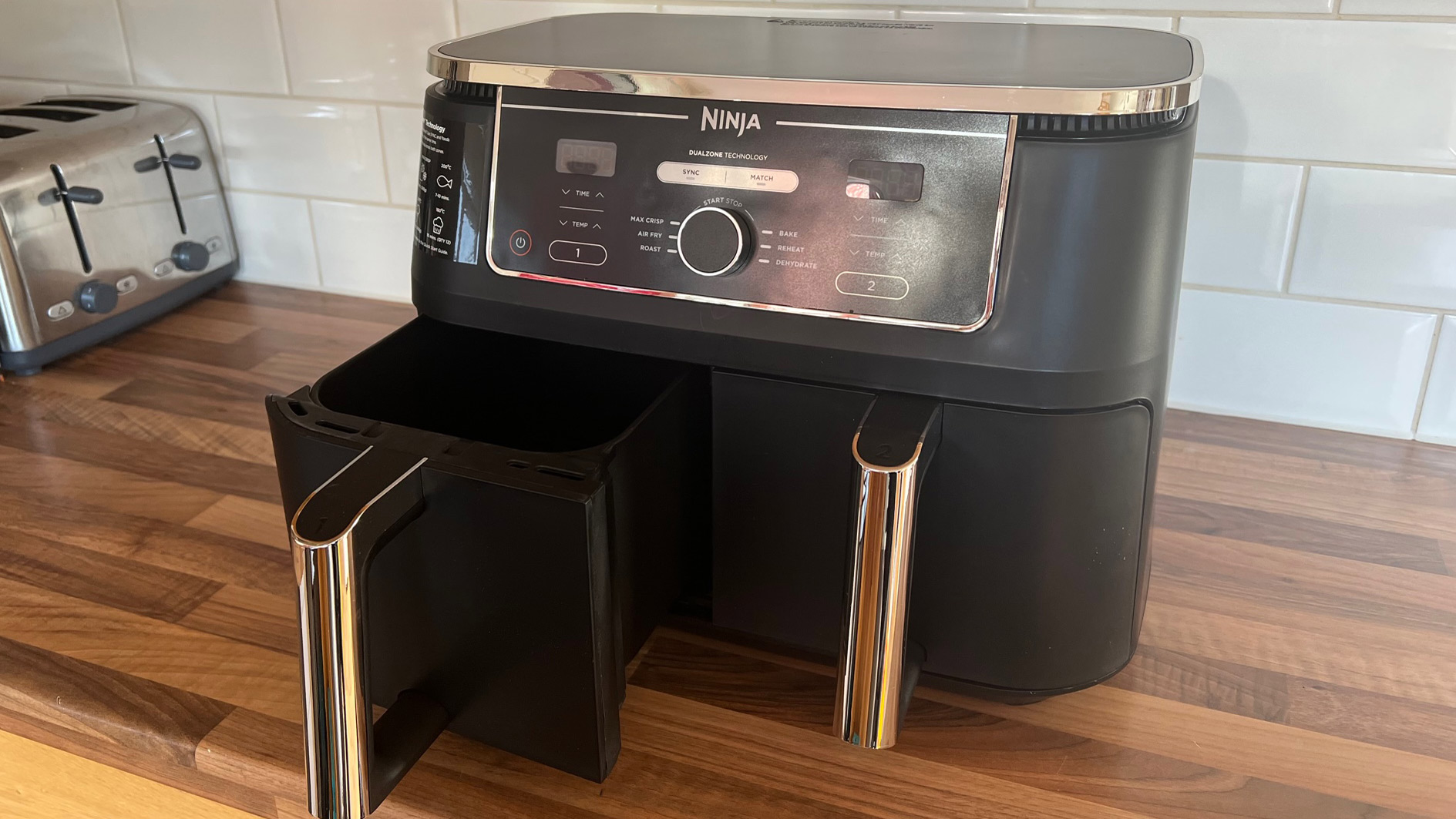 The side view of the Ninja Foodi Max Dual Zone Air Fryer AF400UK with the drawer partially removed