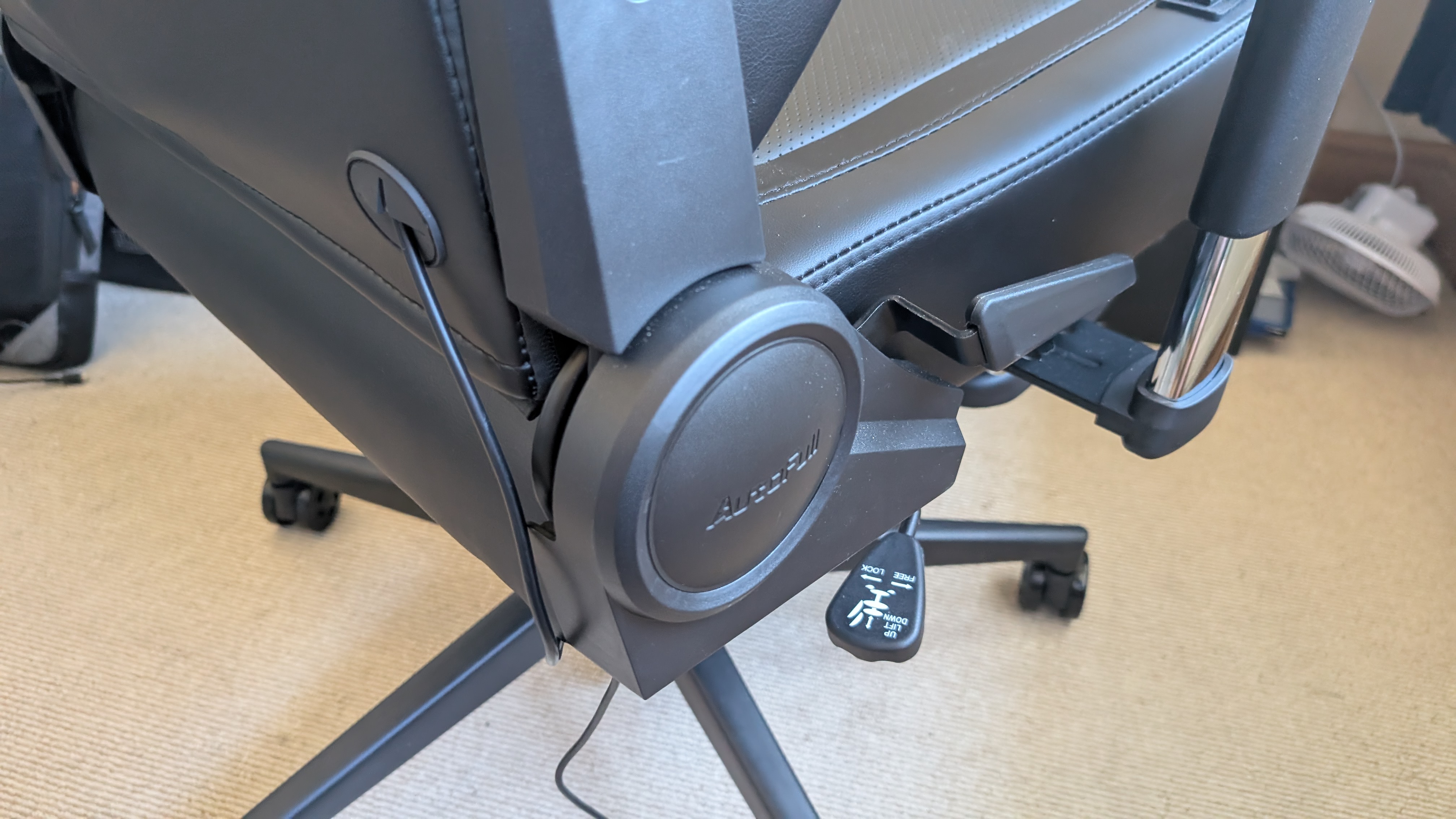 The AutoFull M6 Ultra gaming chair pictured in front of a desk with a gaming PC setup.