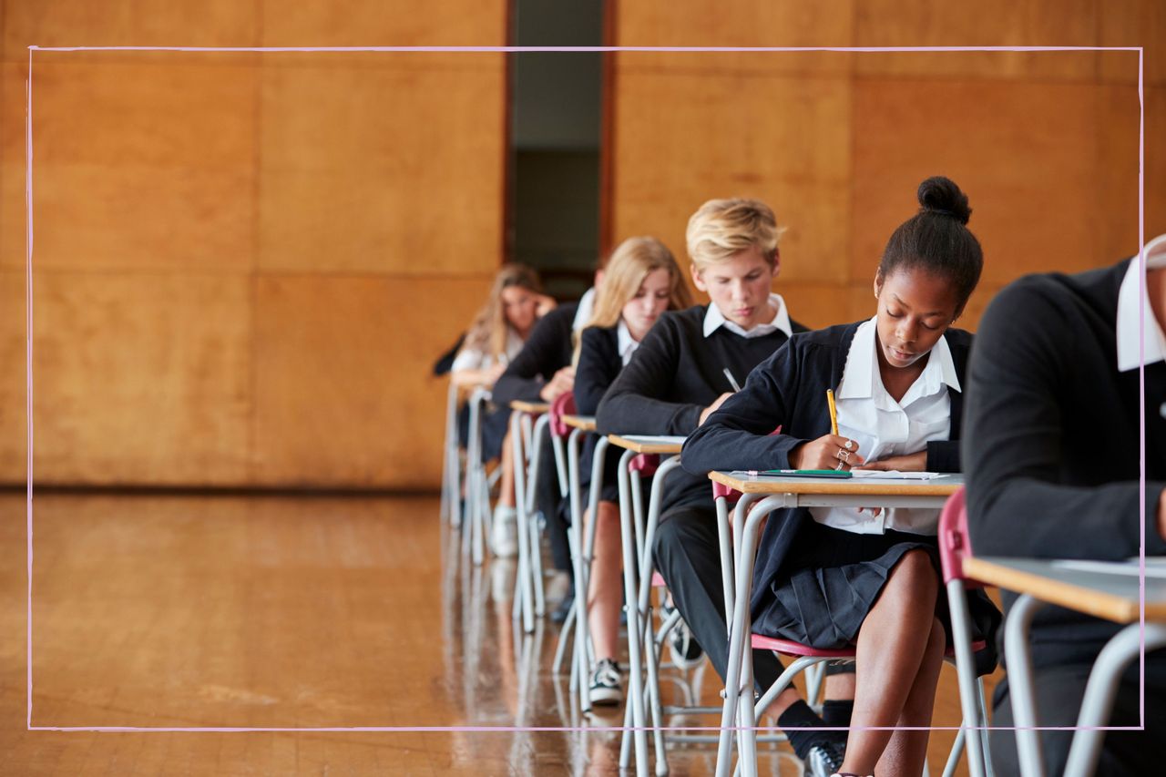 Students sitting exams in a school hall