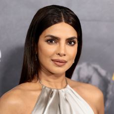 Priyanka Chopra attended the 'Heads of State' premiere in a silver slip dress from Ralph Lauren.