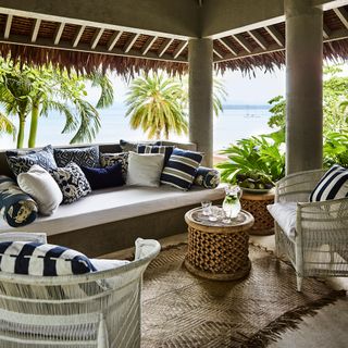 seating area with beach and cushions and arm chairs