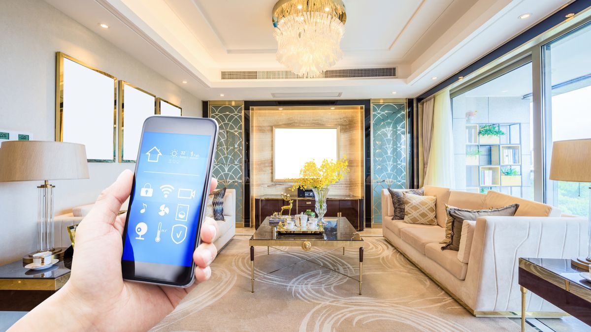 A first person view of a hand holding a smartphone outstretched in a living room.